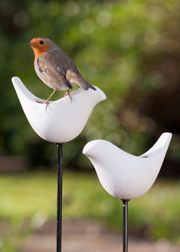 Porcelain bird feeder on a stake