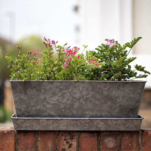Dark galvanised metal window trough tray