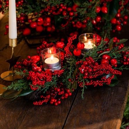 Opulent red berry and foliage centrepiece