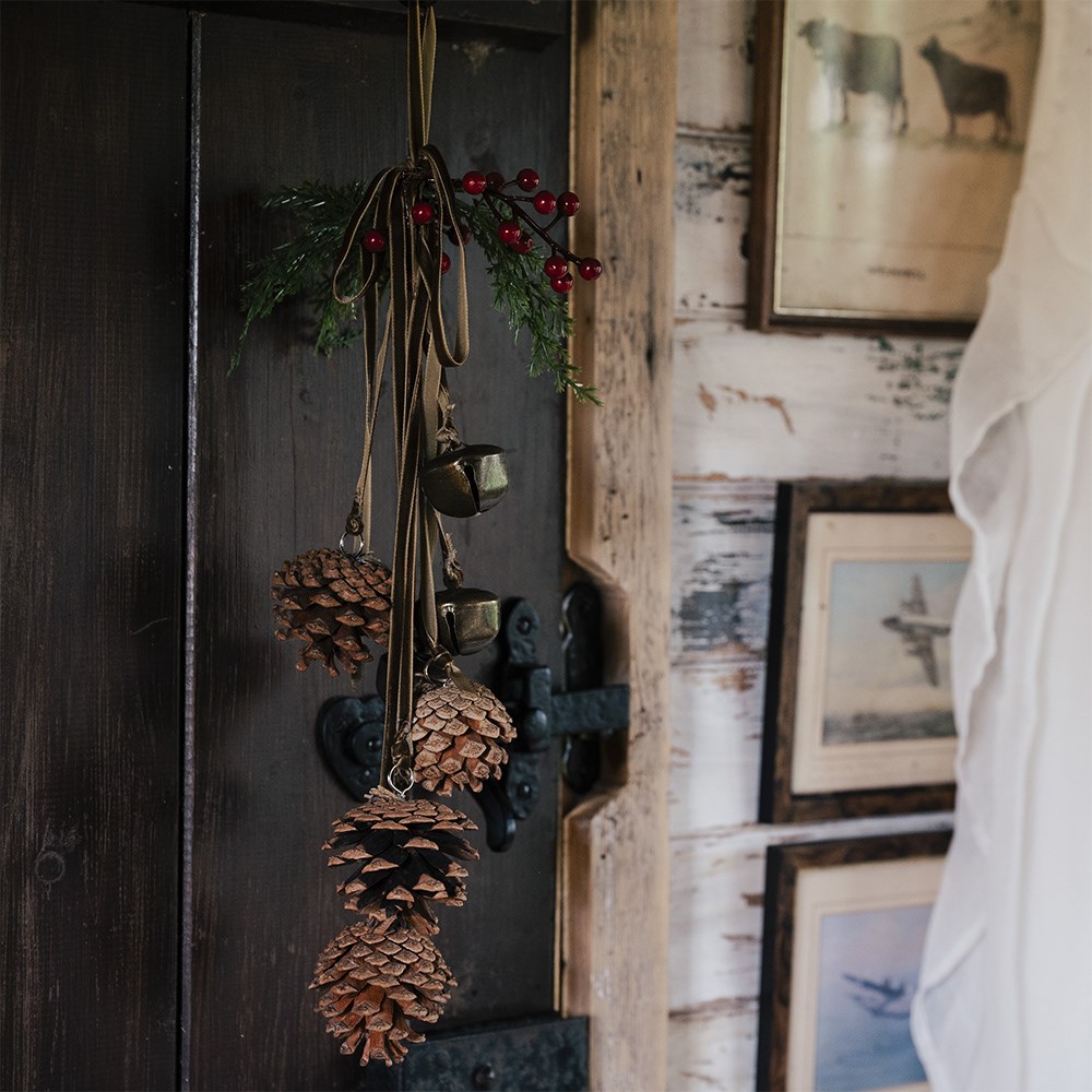 Hanging bell and pinecone decoration