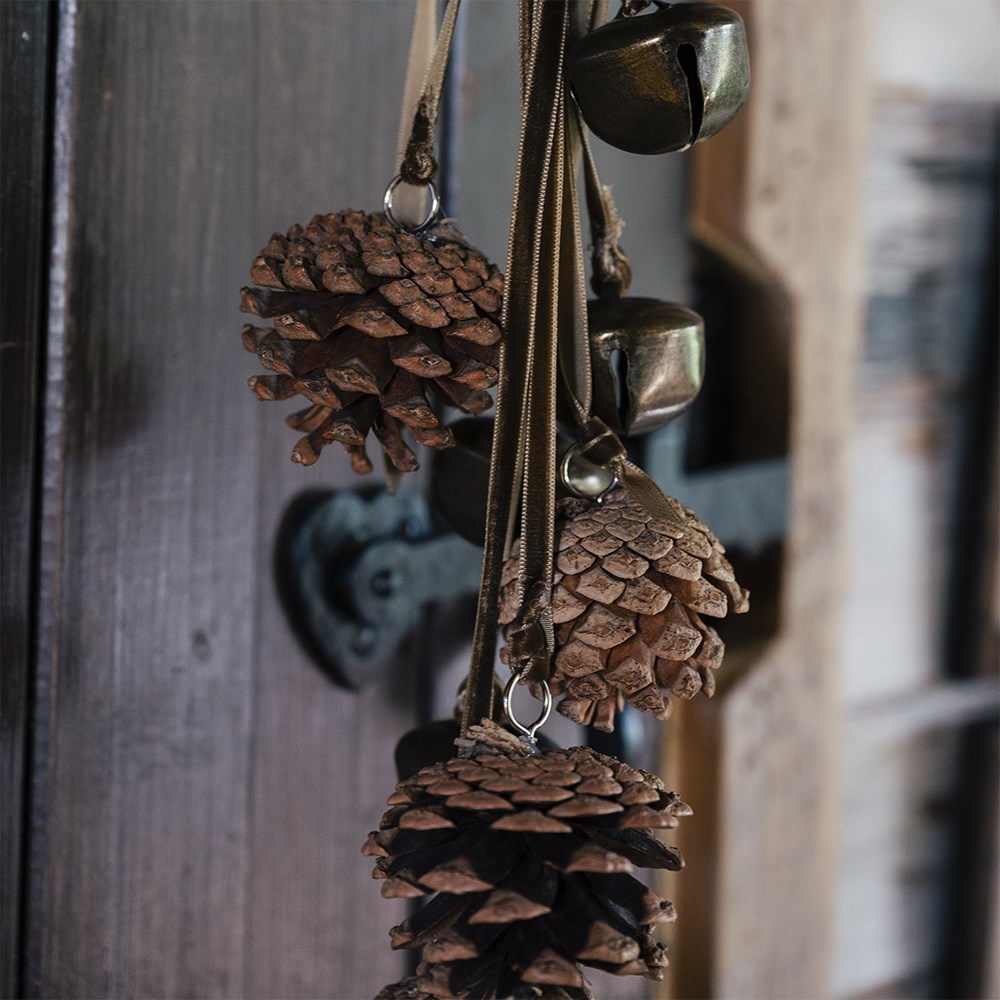 Hanging bell and pinecone decoration