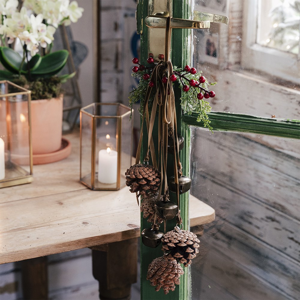 Hanging bell and pinecone decoration