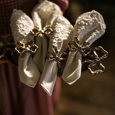 Four gold bow napkin rings